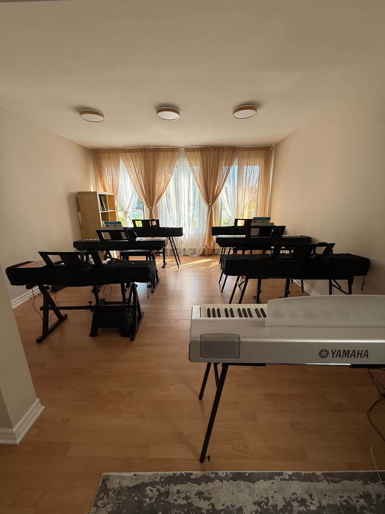 Students learning piano together in a group class